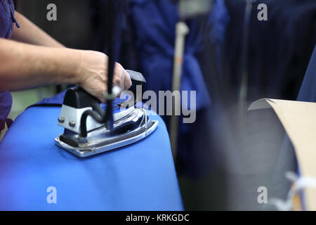 clothing industry. ironing steam. presser in sewing clothes pressed. Stock Photo