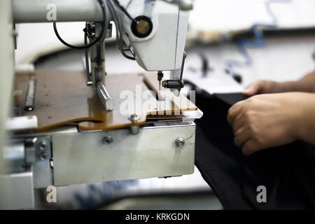 production of clothes,sewing on a machine Stock Photo