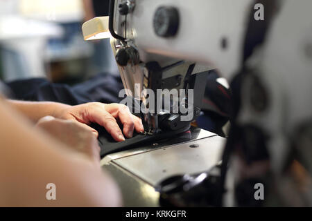 production of clothing,sewing machine overlock. Stock Photo