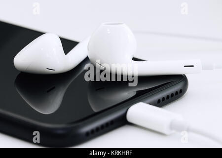 close-up phone and headphone on table Stock Photo