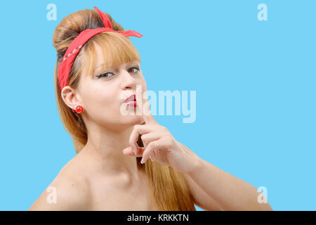 Young woman shows silence finger to his mouth Stock Photo