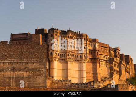 Details of Jodhpur fort at sunset. The majestic fort perched on top dominating the blue town. Scenic travel destination and famous tourist attraction  Stock Photo