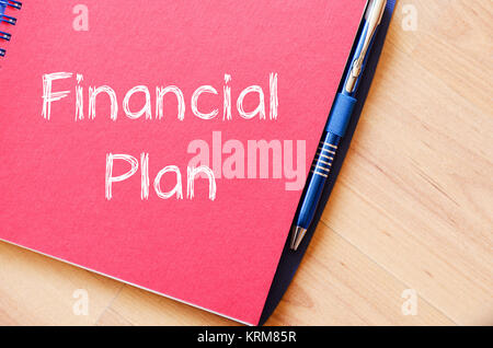 Financial plan text concept on notebook Stock Photo