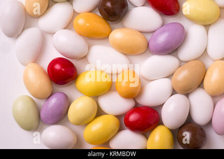 Colored sugared almonds arranged on a white background Stock Photo