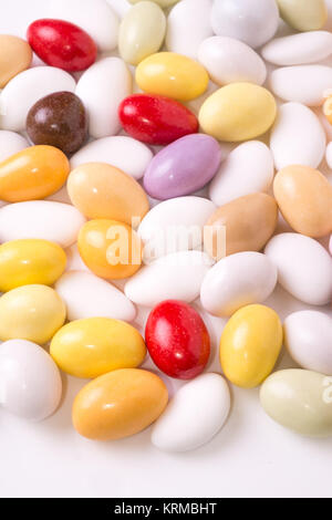 Colored sugared almonds arranged on a white background Stock Photo