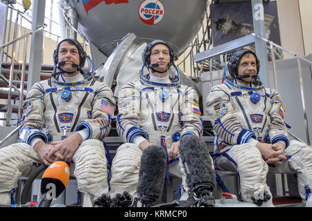 Expedition 47 backup crew members: NASA astronaut Shane Kimbrough, left, Russian cosmonaut Sergei Ryzhikov of Roscosmos, center, and Russian cosmonaut Andre Borisenko of Roscosmos answer questions from the press outside the Soyuz simulator ahead of their Soyuz qualification exams, Wednesday, Feb. 24, 2016, at the Gagarin Cosmonaut Training Center (GCTC) in Star City, Russia. Photo Credit: (NASA/Bill Ingalls) Expedition 47 backup crew members in front of the Soyuz TMA spacecraft mock-up in Star City, Russia Stock Photo