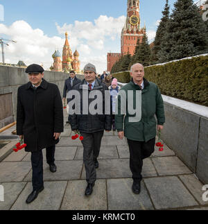 Expedition 47 Russian cosmonauts Oleg Skripochka, left, and Alexei Ovchinin of Roscosmos, along with fellow crew member NASA astronaut Jeff Williams, right, visit Red Square to lay roses at the site where Russian space icons are interred as part of traditional pre-launch ceremonies Friday, Feb. 26, 2016, Moscow, Russia. Photo Credit: (NASA/Bill Ingalls) Expedition 47 Preflight (NHQ201602260002) Stock Photo