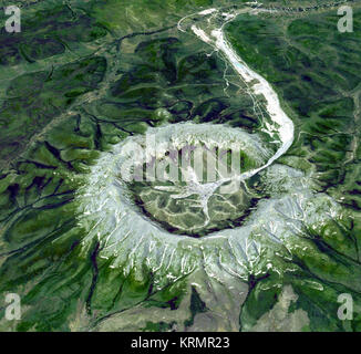 Kondyor Massif, Russia   This is neither an impact crater nor a volcano. It is a perfect circular intrusion, about 10 km in diameter with a topographic ridge up to 600 m high. The Kondyor Massif is located in Eastern Siberia, Russia, north of the city of Khabarovsk. It is a rare form of igneous intrusion called alkaline-ultrabasic massif and it is full of rare minerals. The river flowing out of it forms placer mineral deposits. Last year 4 tons of platinum were mined there. A remarkable and very unusual mineralogical feature of the deposit is the presence of coarse crystals of Pt-Fe alloy, coa Stock Photo