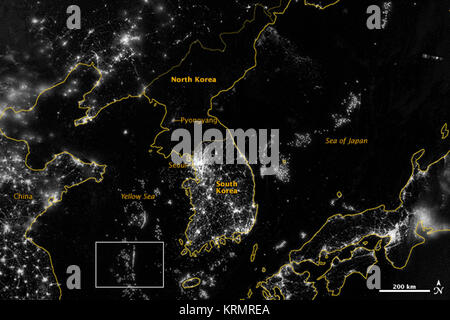 NASA image acquired September 24, 2012  City lights at night are a fairly reliable indicator of where people live. But this isn’t always the case, and the Korean Peninsula shows why. As of July 2012, South Korea’s population was estimated at roughly 49 million people, and North Korea’s population was estimated at about half that number. But where South Korea is gleaming with city lights, North Korea has hardly any lights at all—just a faint glimmer around Pyongyang.  On September 24, 2012, the Visible Infrared Imaging Radiometer Suite (VIIRS) on the Suomi NPP satellite captured this nighttime  Stock Photo