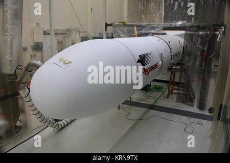 In Building 1555 at Vandenberg Air Force Base in California, an Orbital ATK Pegasus XL rocket is seen after payload fairing installation. On board Pegasus are eight NASA Cyclone Global Navigation Satellite System, or CYGNSS, spacecraft. When preparations are competed at Vandenberg, the L-1011/Pegasus XL combination will be flown to NASA’s Kennedy Space Center in Florida. On Dec. 12, 2016, the carrier aircraft is scheduled to take off from the Skid Strip at Cape Canaveral Air Force Station and CYGNSS will launch on the Pegasus XL rocket with the L-1011 flying off shore. CYGNSS satellites will m Stock Photo