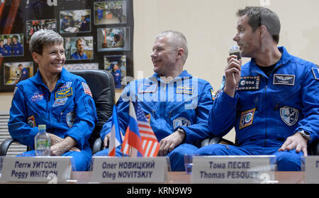 Expedition 50 crew is seen in quarantine behind glass during a crew press conference, from left, NASA astronaut Peggy Whitson, Russian cosmonaut Oleg Novitskiy of Roscosmos, ESA astronaut Thomas Pesquet, Wednesday, Nov. 16, 2016 at the Cosmonaut Hotel in Baikonur, Kazakhstan. Whitson, Novitskiy, and Pesquet will launch from the Baikonur Cosmodrome in Kazakhstan the morning of November 18 (Kazakh time.) All three will spend approximately six months on the orbital complex. Photo Credit: (NASA/Bill Ingalls) Expedition 50 Crew Press Conference (NHQ201611160031) Stock Photo