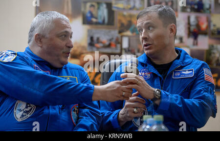 Expedition 50 backup crew members are seen in quarantine behind glass during a crew press conference, from left, Russian cosmonaut Fyodor Yurchikhin of Roscosmos, and NASA astronaut Jack Fischer, Wednesday, Nov. 16, 2016 at the Cosmonaut Hotel in Baikonur, Kazakhstan. NASA astronaut Peggy Whitson, Russian cosmonaut Oleg Novitskiy of Roscosmos, and ESA astronaut Thomas Pesquet will launch from the Baikonur Cosmodrome in Kazakhstan the morning of November 18 (Kazakh time.) All three will spend approximately six months on the orbital complex. Photo Credit: (NASA/Bill Ingalls) Expedition 50 Crew P Stock Photo