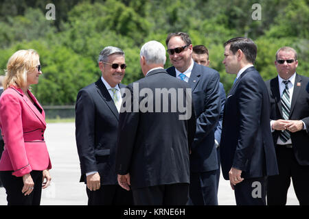 Vice President Mike Pence, back to the camera, is greeted by NASA officials at the Shuttle Landing Facility at NASA's Kennedy Space Center in Florida. From the left are, Deputy Center Director Janet Petro, Center Director Bob Cabana and Acting Administrator Robert Lightfoot. To the right of Lightfoot is Sen. Marco Rubio of Florida. During his visit to Kennedy, the Vice President spoke inside the iconic Vehicle Assembly Building, where he thanked employees for advancing American leadership in space. KSC-20170706-PH KLS01 0063 (35764900965) Stock Photo