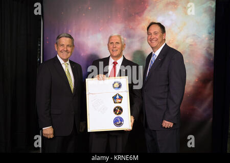 Kennedy Space Center Bob Cabana, left, and NASA's Acting Administrator Robert Lightfoot, right present Vice President Mike Pence with a framed plaque. On the back of the plaque are patches from each of Cabana's four space shuttle mission, STS-88, STS-53, STS-65, STS-41, and an inscription thanking the Vice President for his support of NASA. During his visit to Kennedy, the Vice President spoke inside the iconic Vehicle Assembly Building, where he thanked employees for advancing American leadership in space. KSC-20170706-PH KLS01 0118 (35376786240) Stock Photo