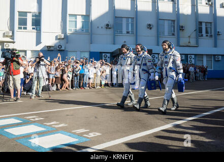 Expedition 52 flight engineer Paolo Nespoli of ESA (European Space Agency), left, flight engineer Sergei Ryazanskiy of Roscosmos, center, and flight engineer Randy Bresnik of NASA, right, walk out Building 254 as they prepare to depart for the launch pad, Friday, July 28, 2017 in Baikonur, Kazakhstan.  The Soyuz rocket launched at 11:41 a.m. EDT on July 28 (9:41 p.m. Baikonur time) to start Ryazanskiy, Bresnik, and Nespoli on a four and a half month mission aboard the International Space Station.  Photo Credit: (NASA/Joel Kowsky) Expedition 52 Preflight (NHQ201707280066) Stock Photo
