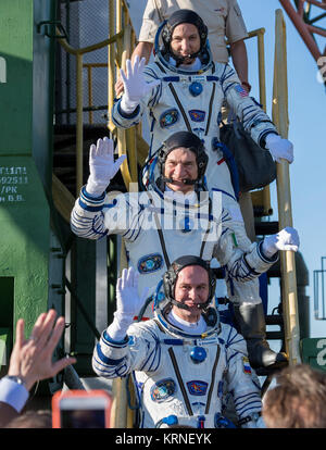 Expedition 52 flight engineer Randy Bresnik of NASA, top, flight engineer Paolo Nespoli of ESA (European Space Agency), middle, and flight engineer Sergei Ryazanskiy of Roscosmos, bottom, wave farewell prior to boarding the Soyuz MS-05 rocket for launch, Friday, July 28, 2017 at the Baikonur Cosmodrome in Kazakhstan.  Ryazanskiy, Bresnik, and Nespoli will spend the next four and a half months living and working aboard the International Space Station.  Photo Credit: (NASA/Joel Kowsky) Expedition 52 Preflight (NHQ201707280004) Stock Photo