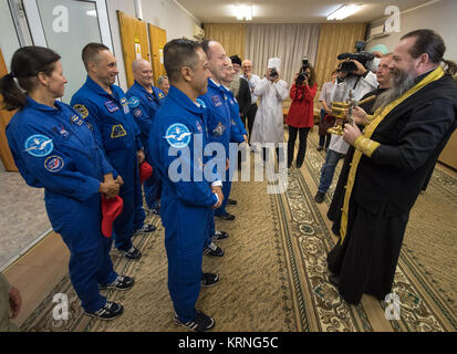 Russian Orthodox Priest, father Sergei, right, blesses Expedition 53 crewmembers Joe Acaba of NASA, front left, Alexander Misurkin of Roscosmos, front center, and Mark Vande Hei of NASA, front right, as backup crew members, Shannon Walker of NASA, back left, Anton Shkaplerov of Roscosmos, back center, and Scott Tingle of NASA look on Tuesday, Sept. 12, 2017 at the Cosmonaut Hotel in Baikonur, Kazakhstan. Acaba, Misurkin, and Vande Hei will launch onboard a Soyuz MS-06 spacecraft and spend approximately five and half months on the International Space Station. Photo Credit: (NASA/Bill Ingalls) E Stock Photo