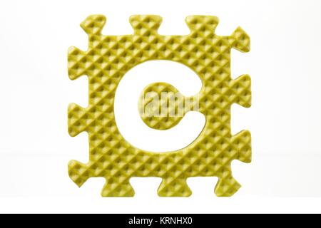 rubber alphabet puzzle with a detached letter c Stock Photo