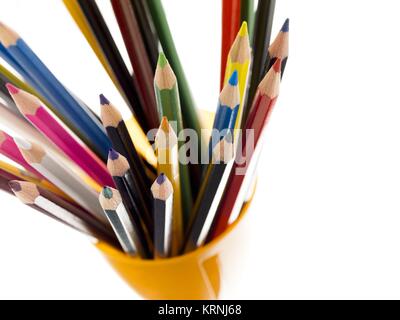 stacked of colorful pencil on yellow holder Stock Photo