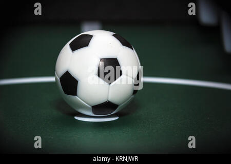 Soccer table game. Green field and plastic ball on it. Sport background Stock Photo