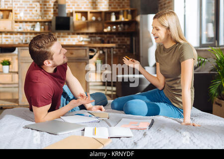 Cute merry couple sharing their ideas Stock Photo