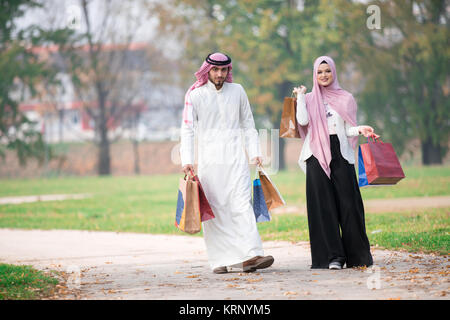 https://l450v.alamy.com/450v/krnym5/lovely-muslim-couple-taking-a-walk-after-shopping-concept-krnym5.jpg