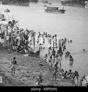 Black and white photograph of people bathing in the River Ganges around the end of the nineteenth or early twentieth century. Stock Photo