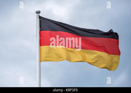 The flag of Germany fluttering on wind. Stock Photo