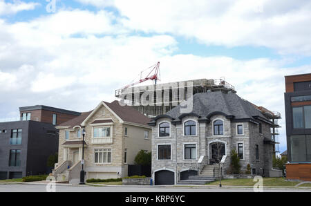 Expensive houses and the building construction behind, Montreal, Canada Stock Photo