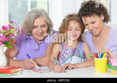 three generations of women from one family doing homework   Stock Photo