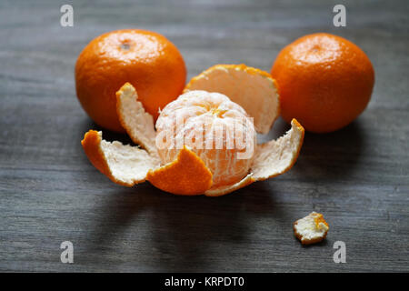 clementines or mandarin oranges on rustic wooden table Stock Photo