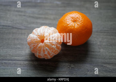 clementines or tangerines or mandarin oranges on rustic wooden table Stock Photo