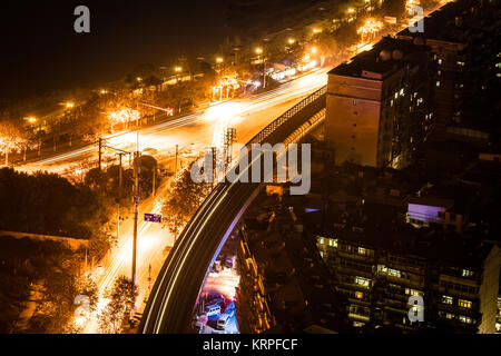 Aerial night view of a road junctions with cars lights trail in Wuhan central China Stock Photo