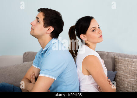 Close Up Of Sad Couple Sitting Back To Back Stock Photo