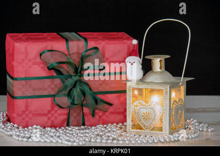 Christmas gifts and a lantern with candle Stock Photo