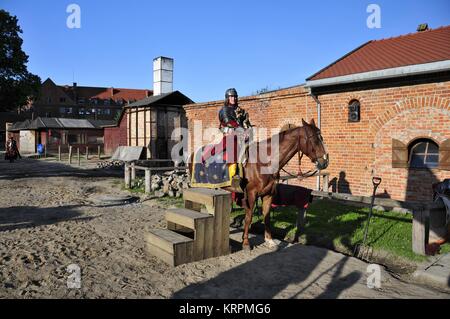 Gniew Castle, one of the most recognizable landmarks in Pomerania, Poland. Pictured: knight in the castle courtyard. Stock Photo