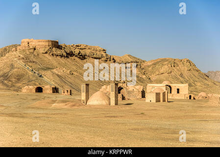 Towers of silence in a barren desert under clear blue skies Stock Photo