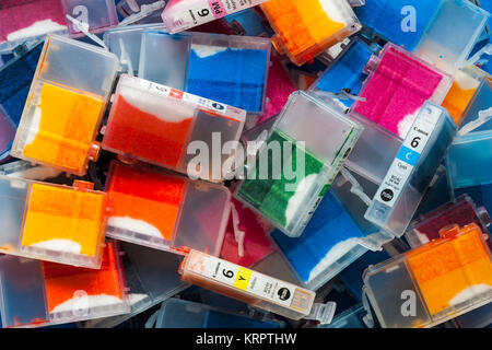 Pile of used empty Canon ink cartridges ready to return for recycling after printing using home computer and inkjet printer Stock Photo