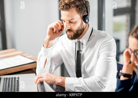 Man working with headset at the office Stock Photo