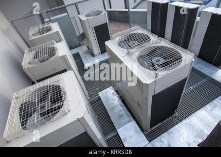 Air conditioning equipment atop a modern building - aerial/drone view of the roof with all the necessary installations Stock Photo