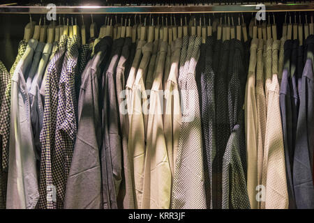 Men shirts on racks in a clothing shop in London Stock Photo