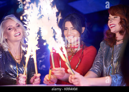 Happy woman holding burning sparklers Stock Photo