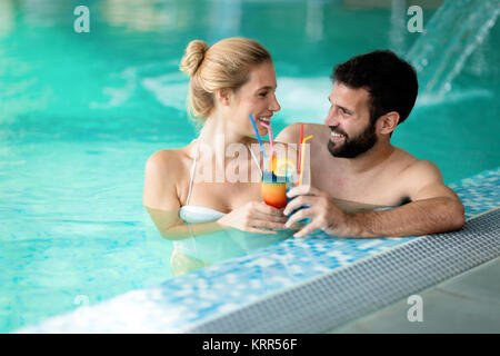 Picture of happy couple relaxing in pool Stock Photo