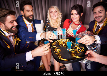 Group of friends drinking blue curacao at night club Stock Photo