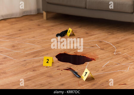 chalk outline and knife in blood at crime scene Stock Photo
