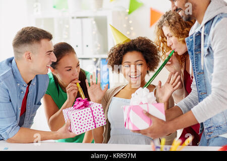 team greeting colleague at office birthday party Stock Photo