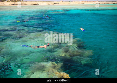 People snorkeling in a beautiful coral reef near Port Ghalib. Marsa Alam, Egypt Stock Photo