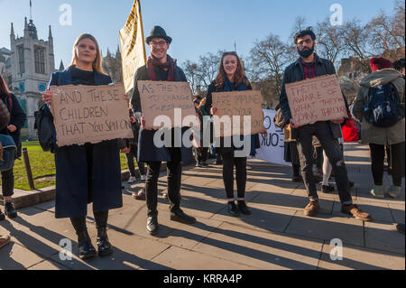 Protesters hold four posters with a quote 'And these children that you spit on...' from David Bowie's 'Changes' at NCAFC 'Grants Not Debt' protest in Parliament Square against scrapping of student maintenance. Stock Photo