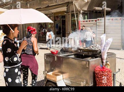 Traditional sale of roasted chestnuts on the streets of the historic center of Lisbon, Portugal Stock Photo