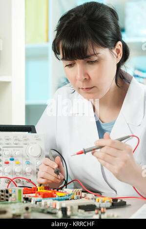 Tech repairs electronic device in modern laboratory Stock Photo